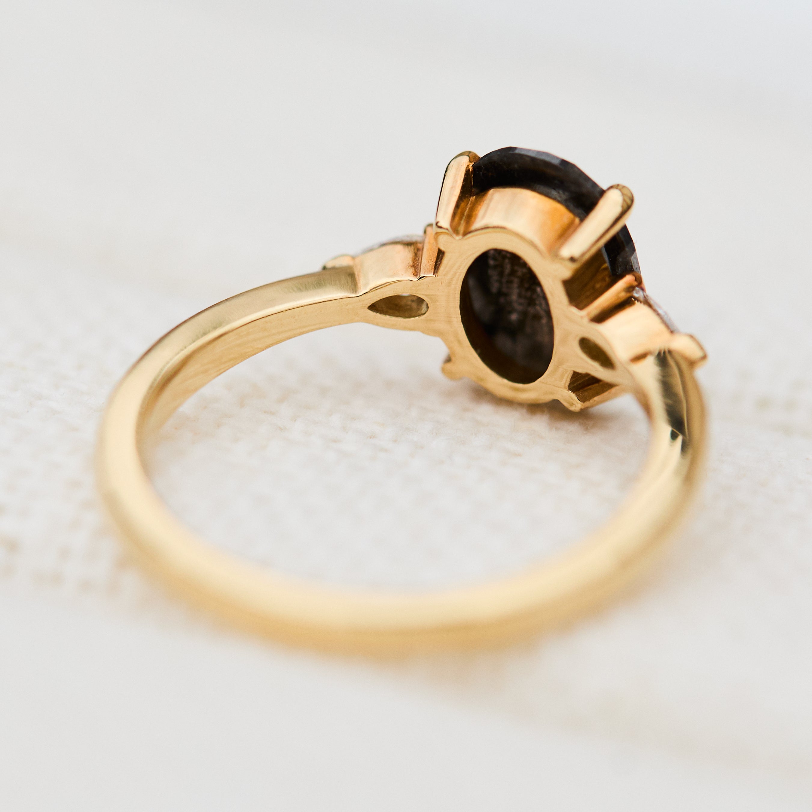 black oval salt and pepper diamond engagement ring in yellow gold