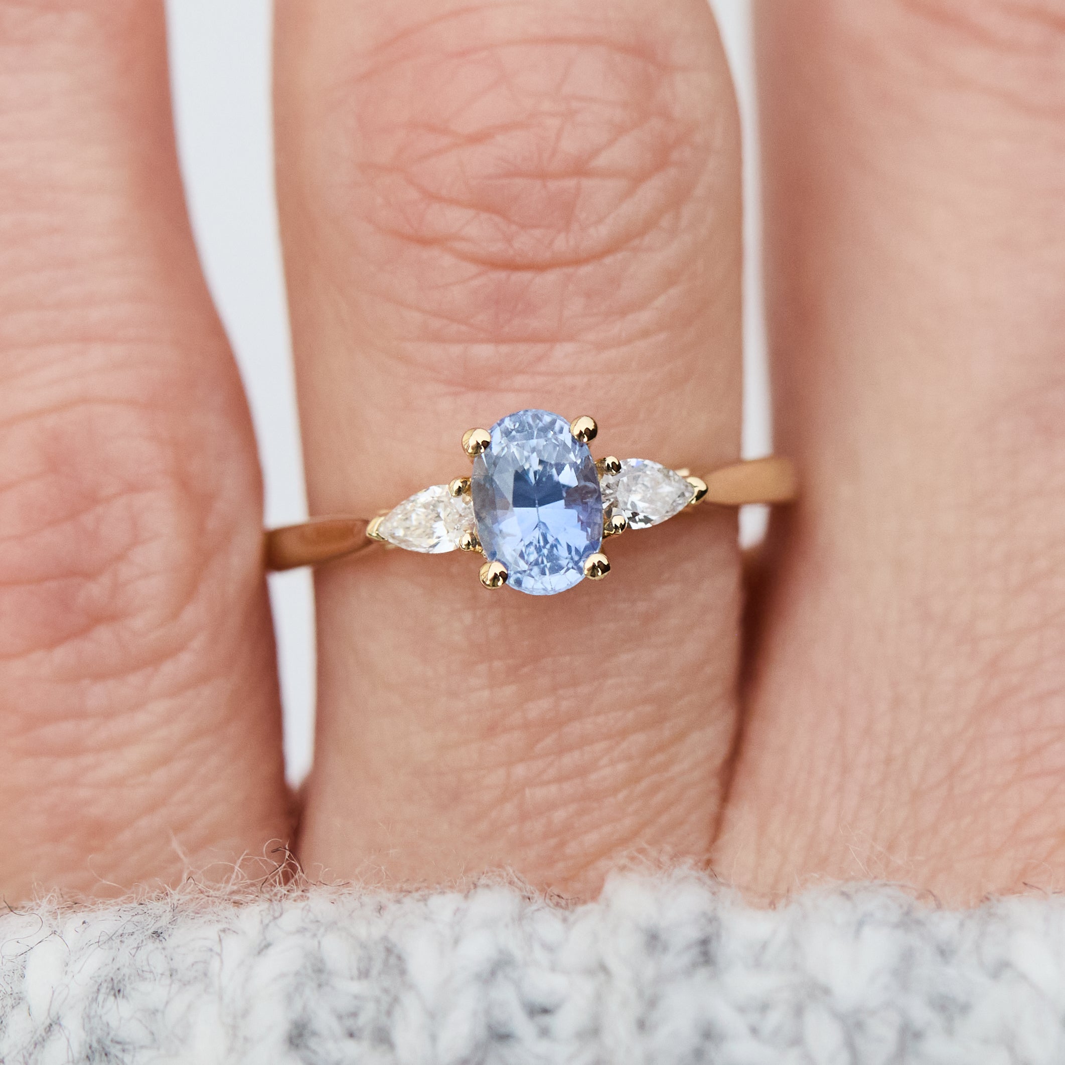 blue sapphire yellow gold trilogy engagement ring