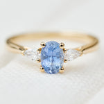 blue sapphire yellow gold trilogy engagement ring