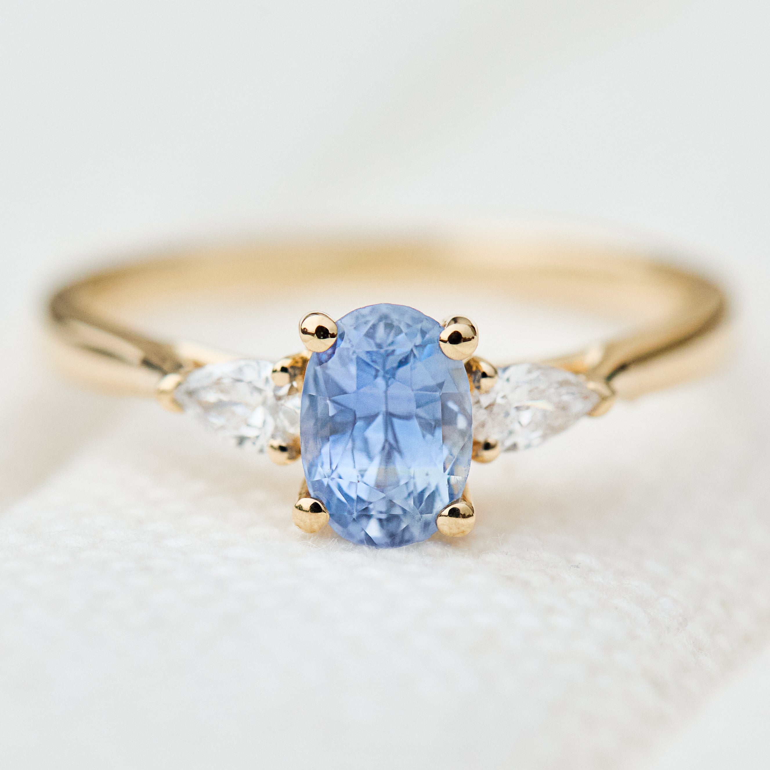 blue sapphire yellow gold trilogy engagement ring