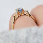 blue sapphire yellow gold trilogy engagement ring