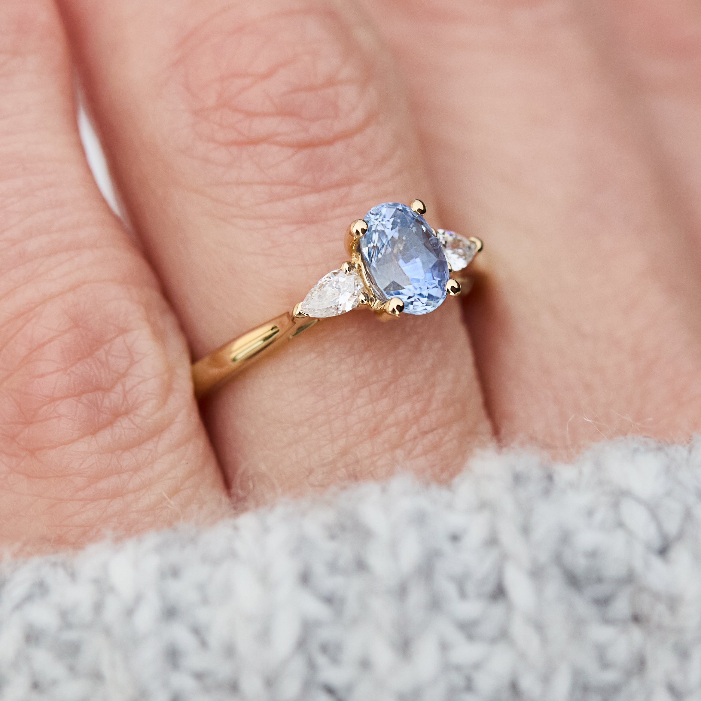 blue sapphire yellow gold trilogy engagement ring