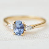 blue sapphire yellow gold trilogy engagement ring