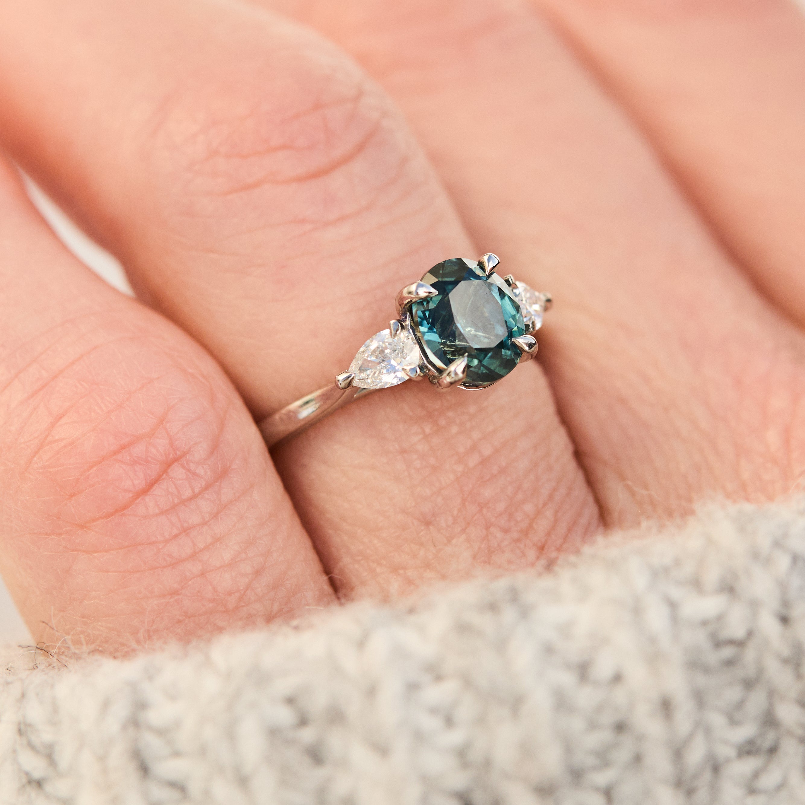oval blue teal sapphire platinum trilogy engagement ring