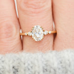 cushion cut moissanite and diamond engagement ring in yellow gold