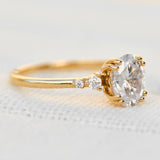 cushion cut moissanite and diamond engagement ring in yellow gold