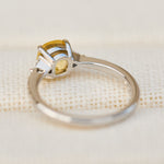 cushion cut yellow sapphire trilogy engagement ring in platinum
