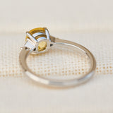cushion cut yellow sapphire trilogy engagement ring in platinum