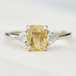 cushion cut yellow sapphire platinum trilogy engagement ring