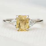 cushion cut yellow sapphire platinum trilogy engagement ring