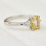 cushion cut yellow sapphire platinum trilogy engagement ring