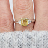 cushion cut yellow sapphire platinum trilogy engagement ring