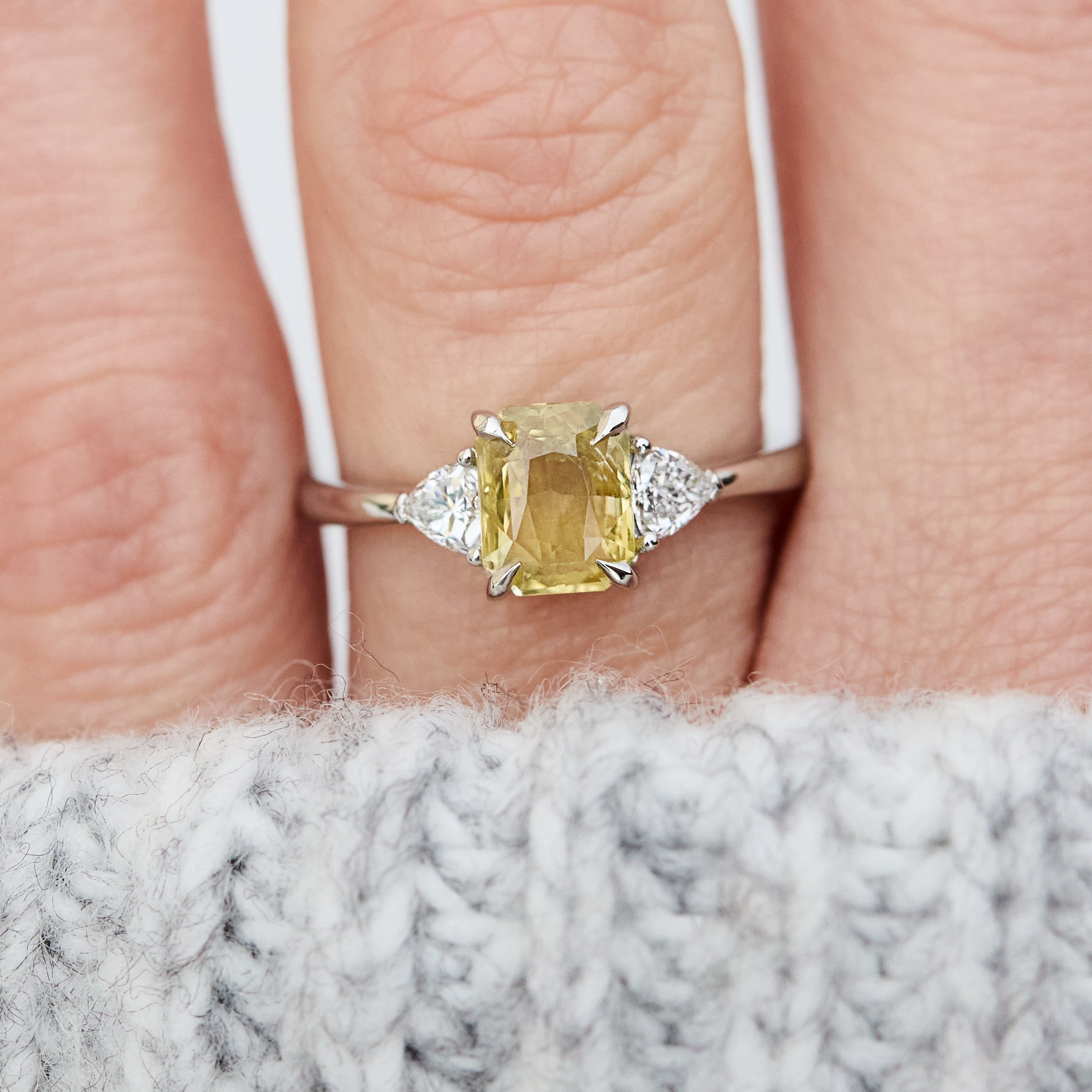 cushion cut yellow sapphire platinum trilogy engagement ring