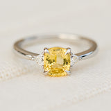 cushion cut yellow sapphire trilogy engagement ring in platinum
