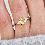 cushion cut yellow sapphire trilogy engagement ring in platinum