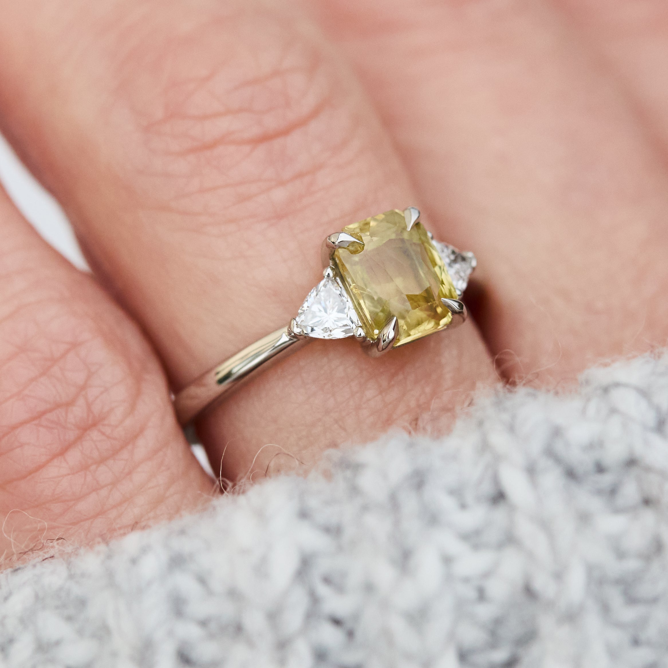 cushion cut yellow sapphire platinum trilogy engagement ring