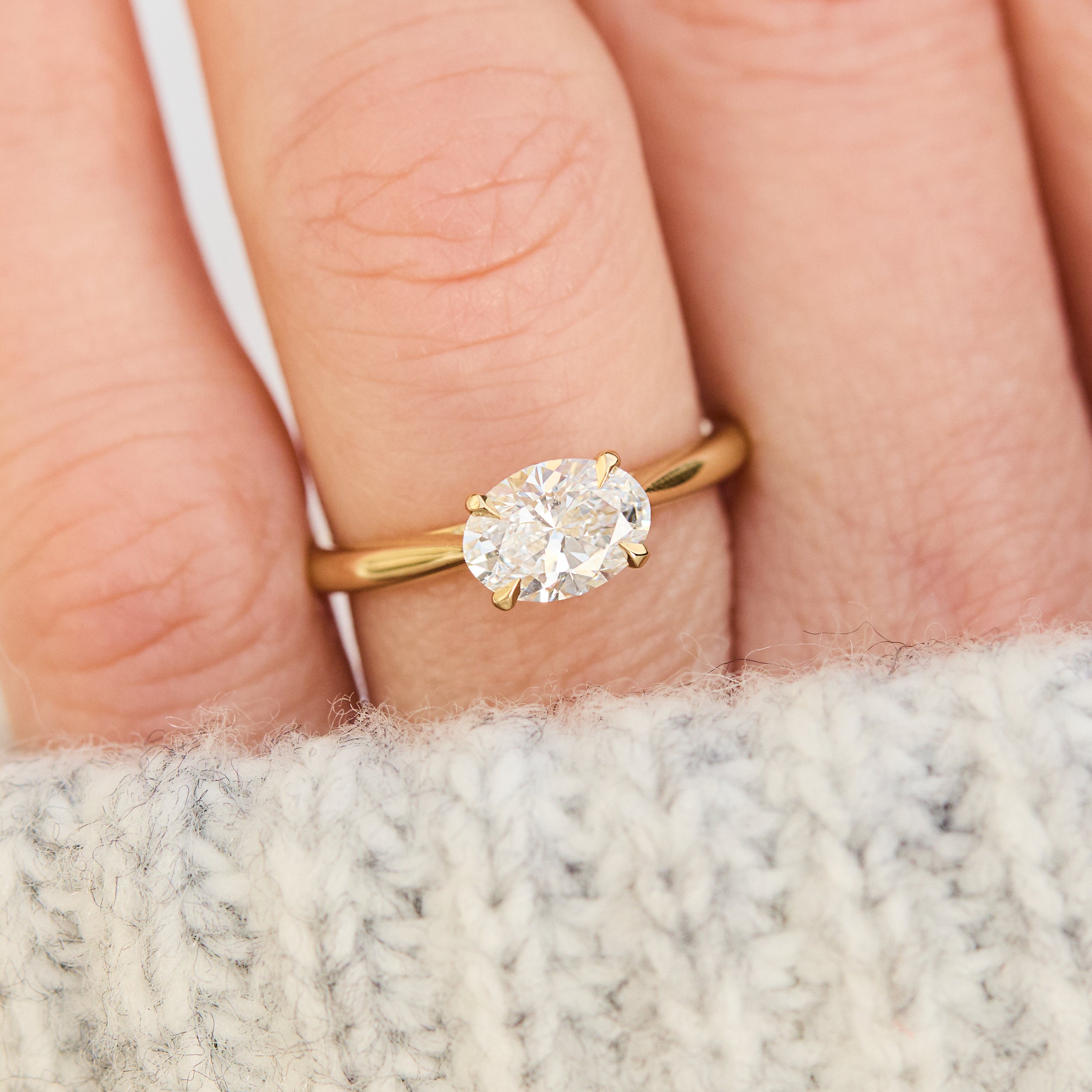 east west oval lab grown diamond engagement ring in yellow gold