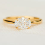 east west oval lab grown diamond engagement ring in yellow gold