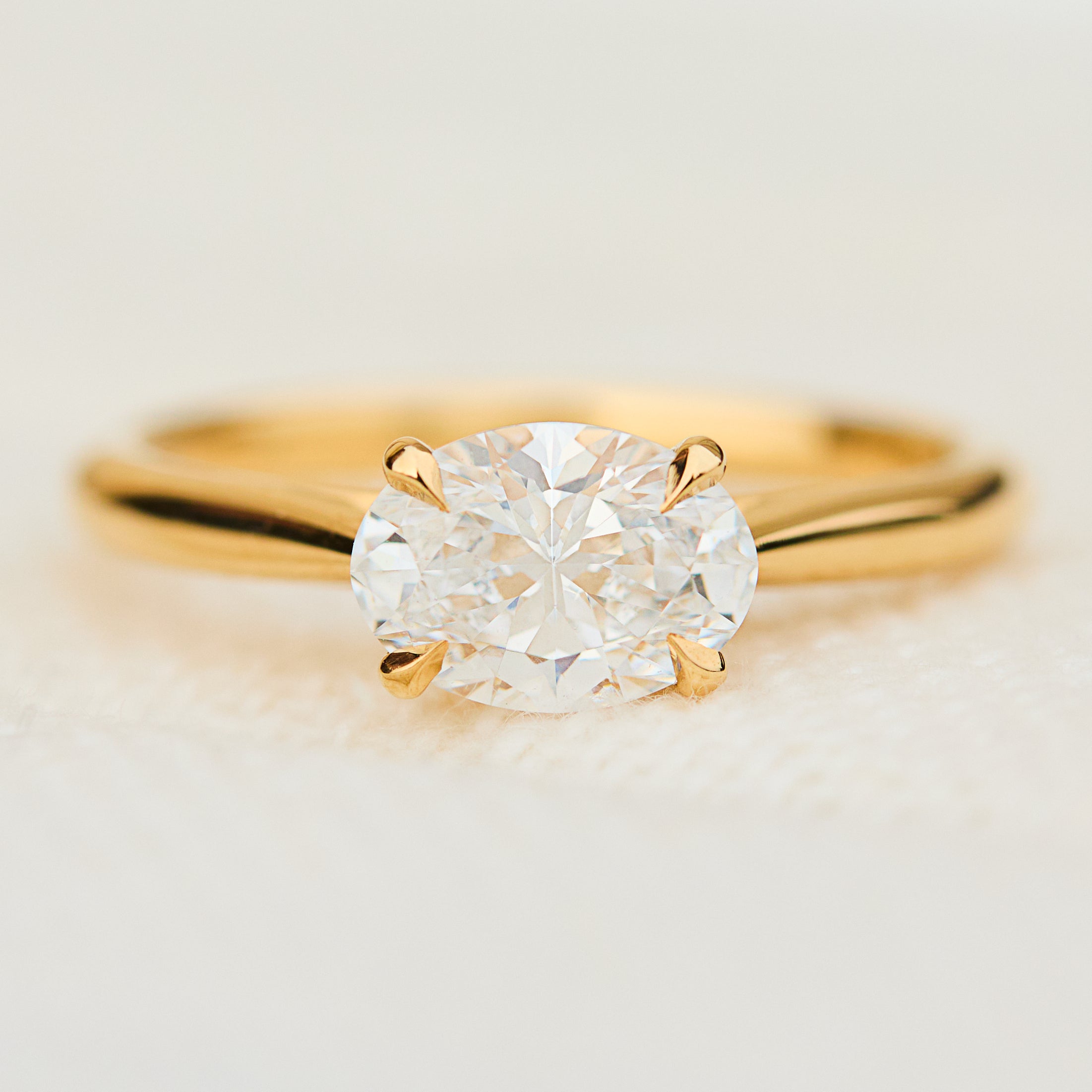 east west oval lab grown diamond engagement ring in yellow gold