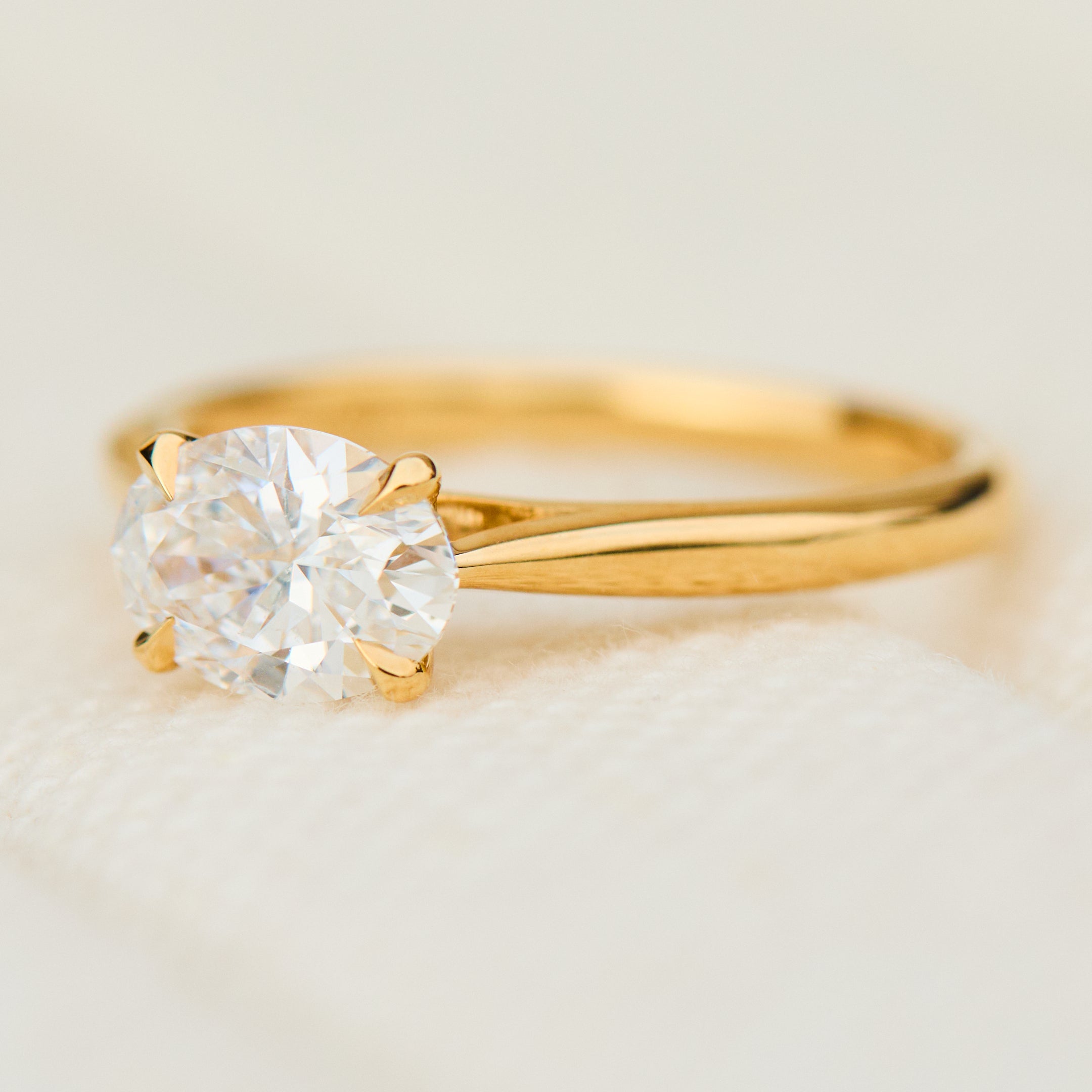east west oval lab grown diamond engagement ring in yellow gold