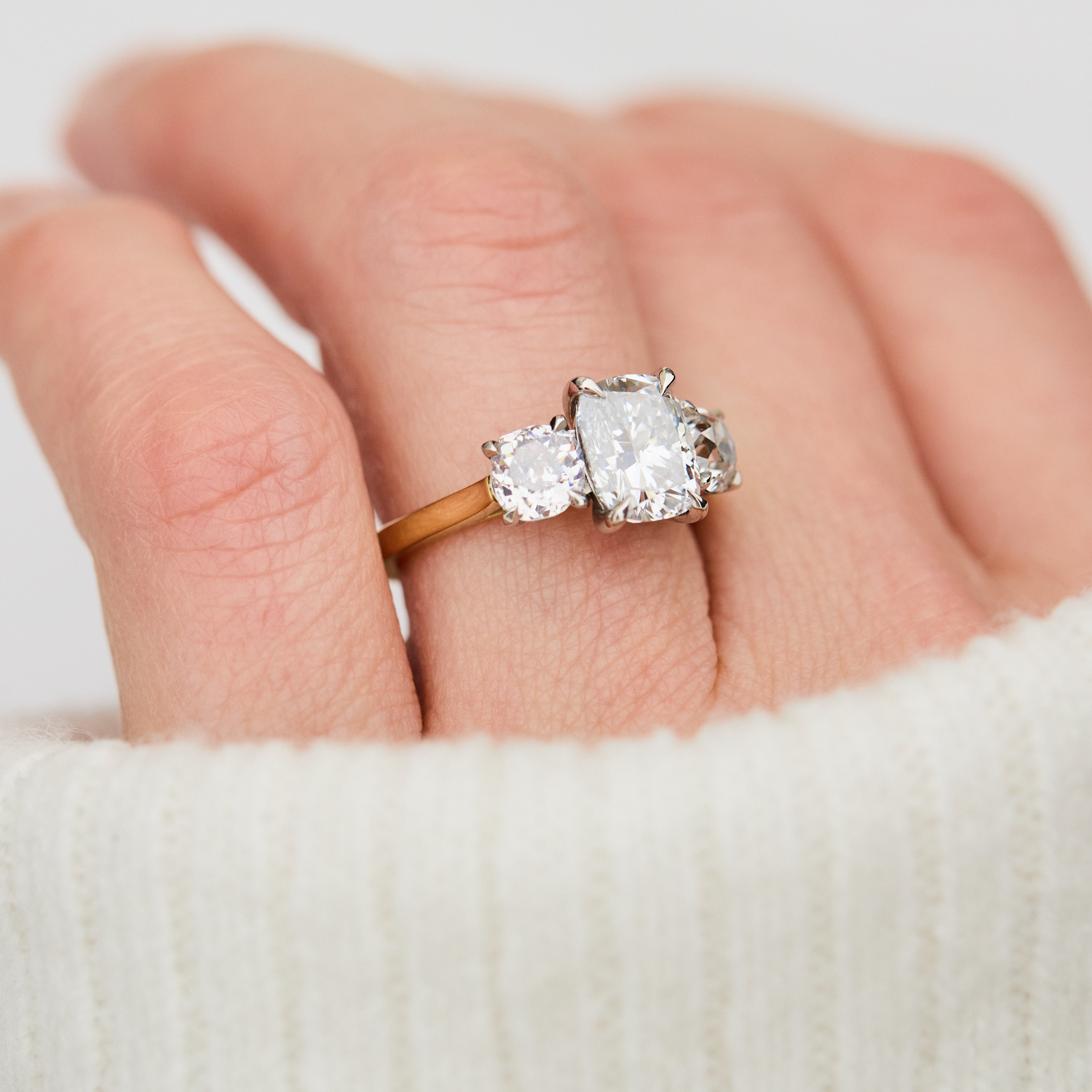 elongated cushion lab grown diamond trilogy engagement ring in yellow gold