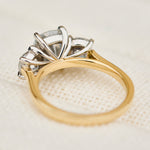 elongated cushion lab grown diamond trilogy engagement ring in yellow gold