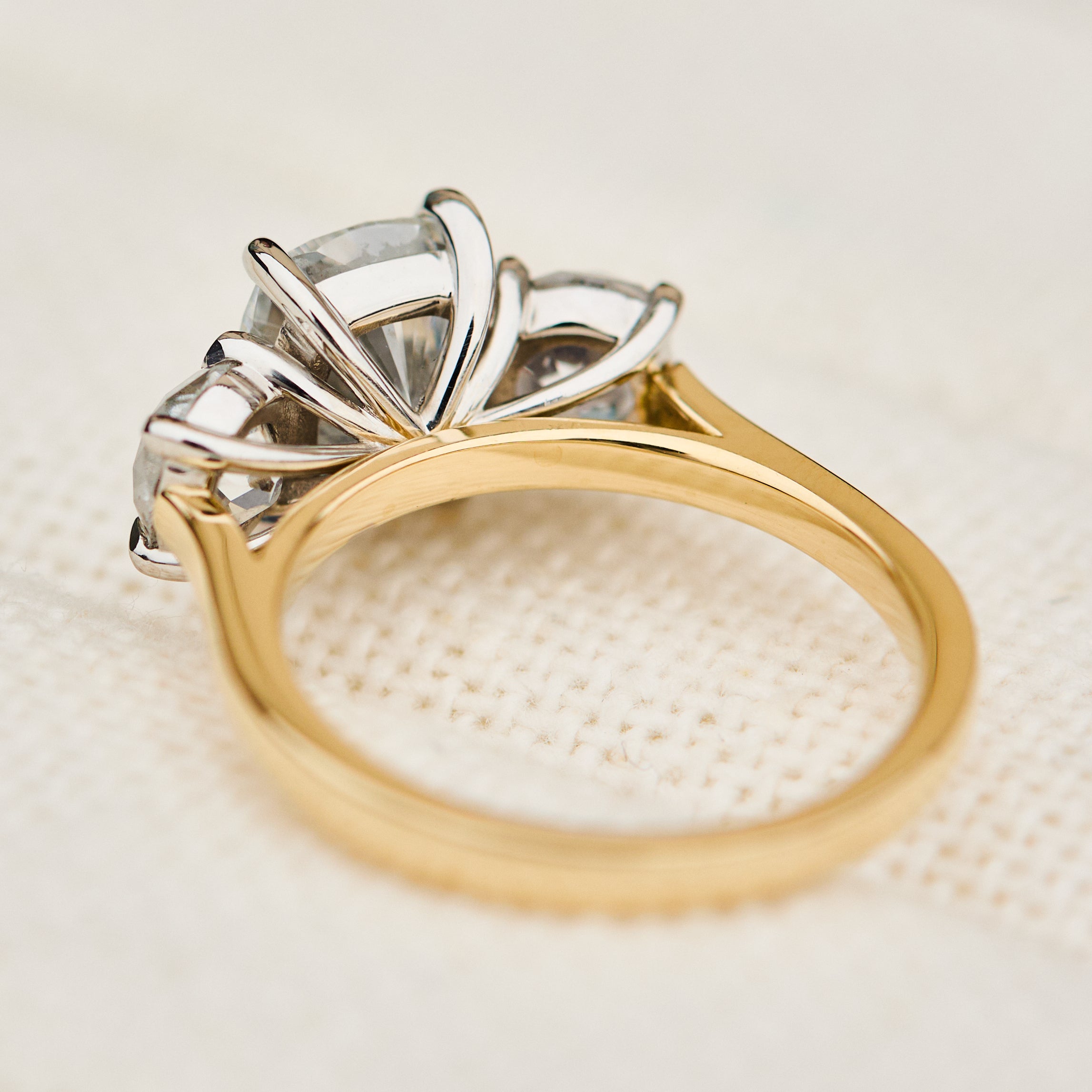 elongated cushion lab grown diamond trilogy engagement ring in yellow gold