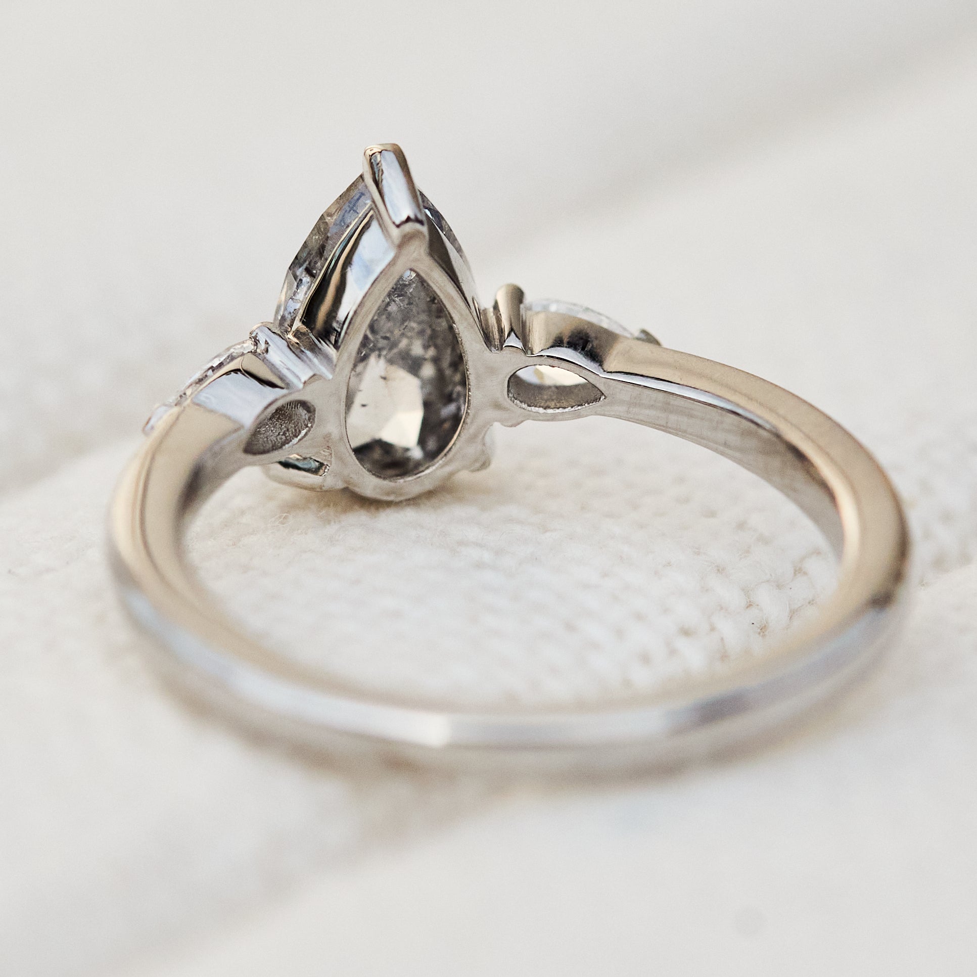 elongated pear shape salt and pepper diamond trilogy platinum engagement ring