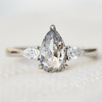 elongated pear shape salt and pepper diamond trilogy platinum engagement ring