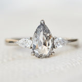 elongated pear shape salt and pepper diamond trilogy platinum engagement ring