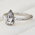 elongated pear shape salt and pepper diamond trilogy platinum engagement ring