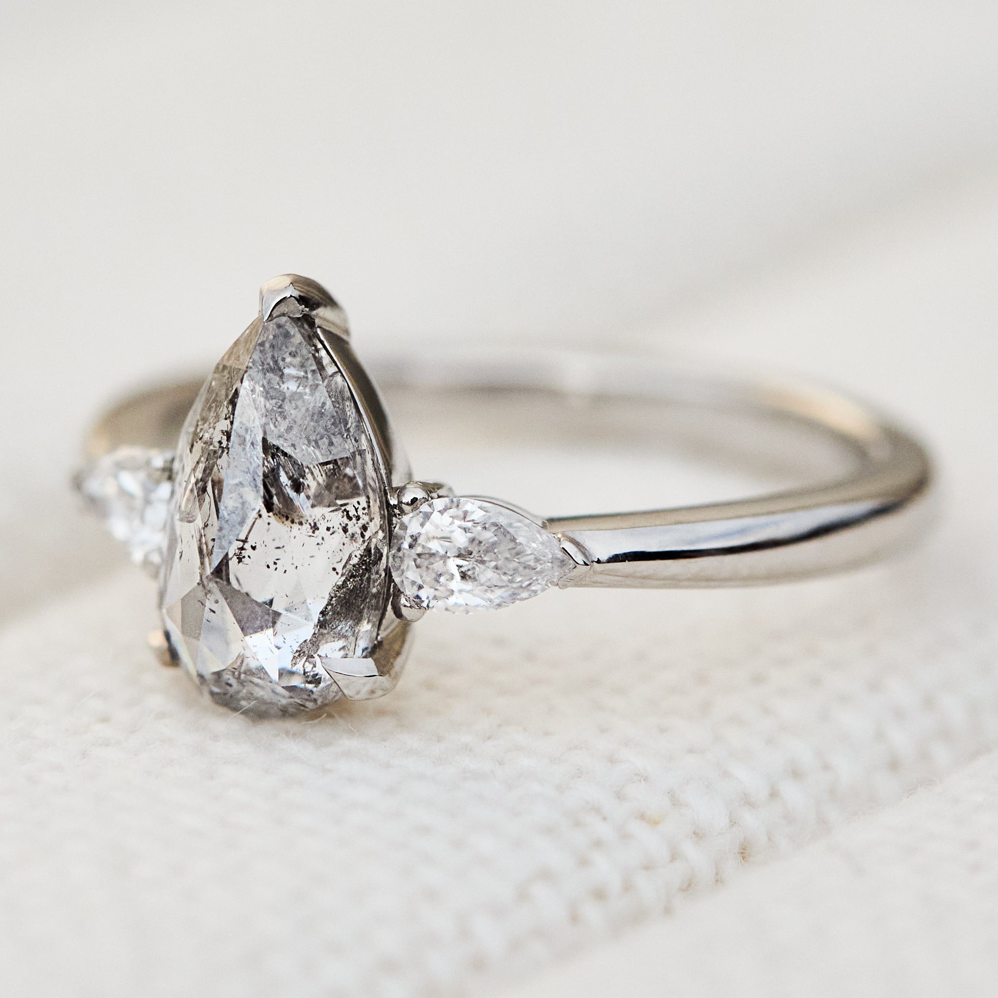 elongated pear shape salt and pepper diamond trilogy platinum engagement ring