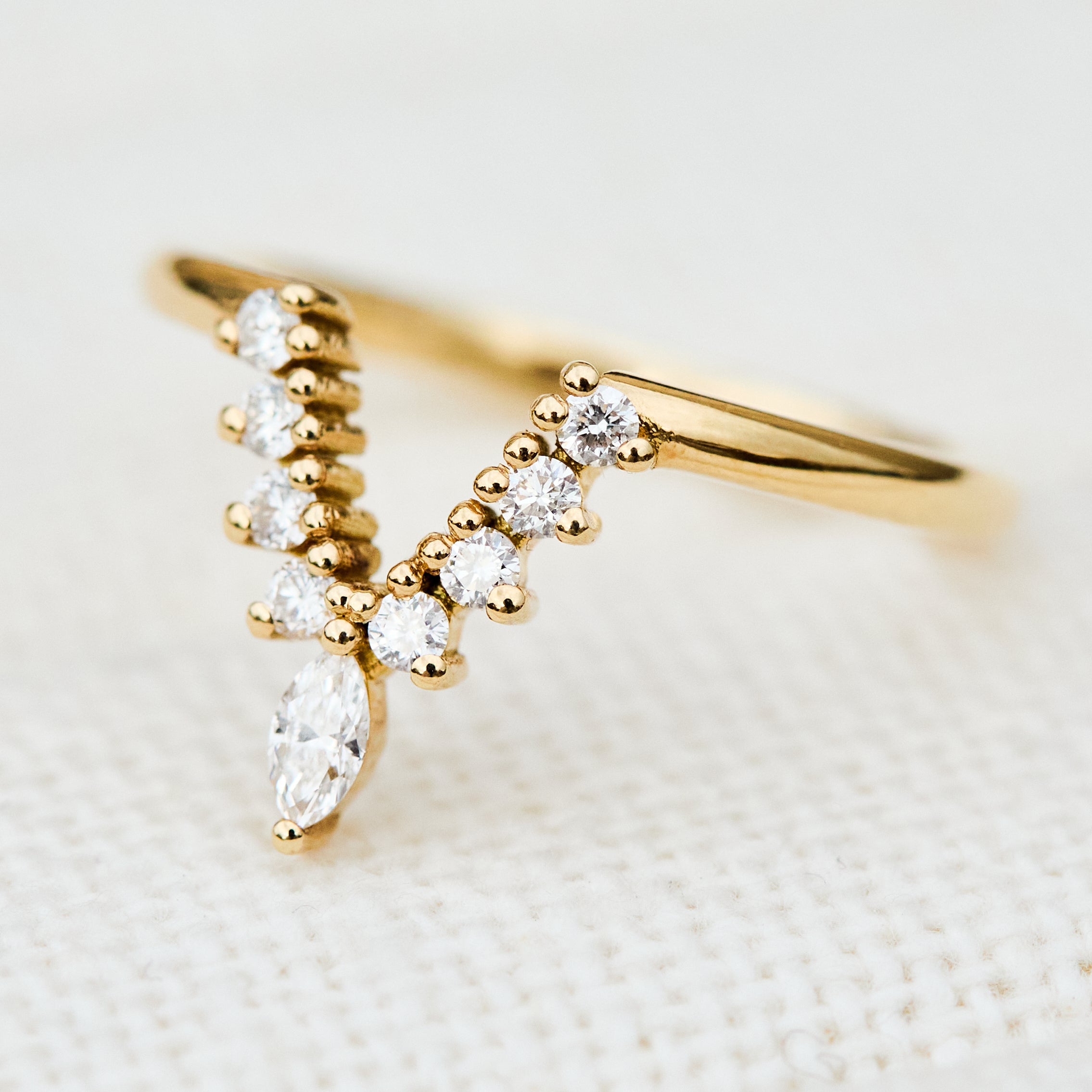 elongated v shaped diamond wedding band in yellow gold