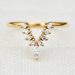 elongated v shaped diamond wedding band in yellow gold