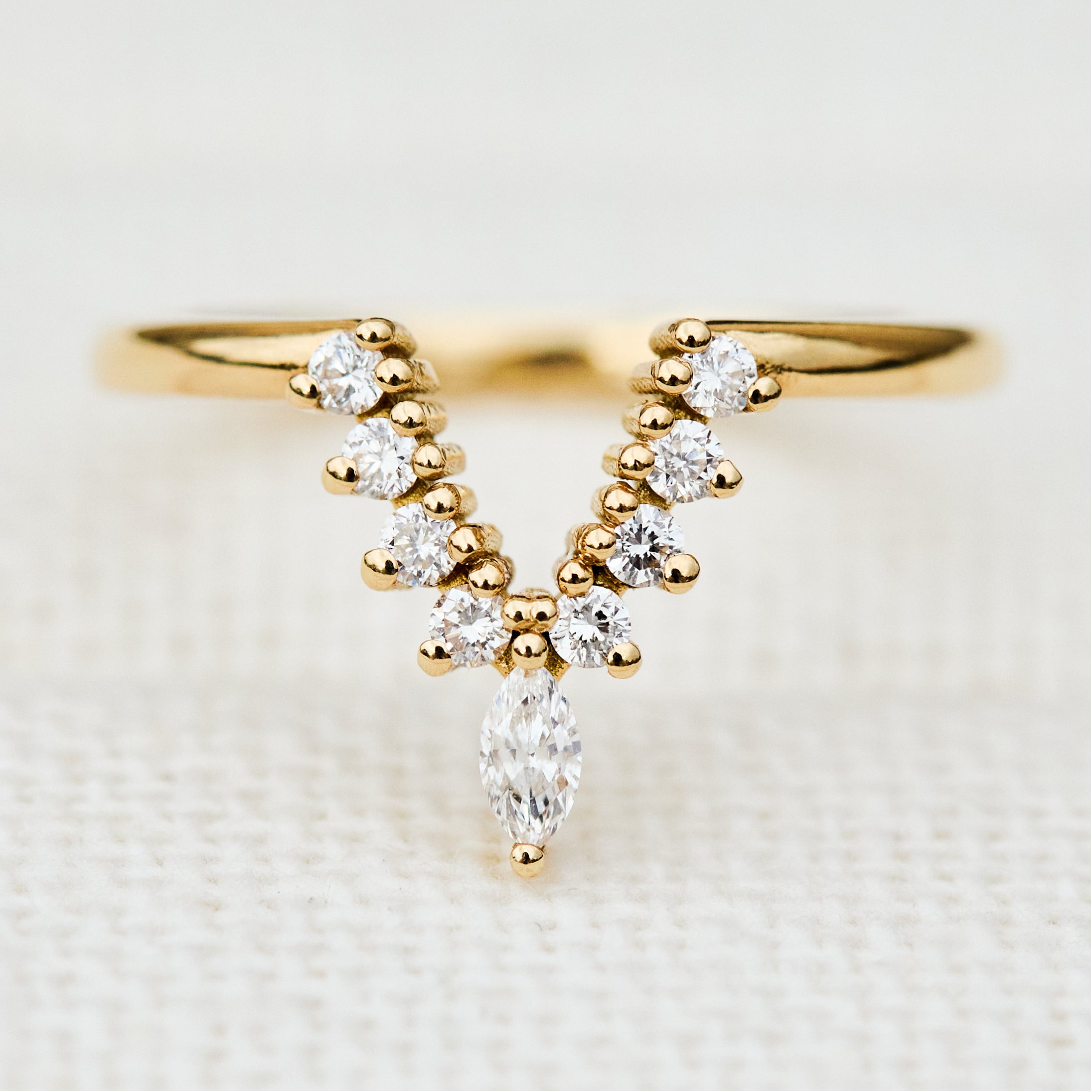 elongated v shaped diamond wedding band in yellow gold
