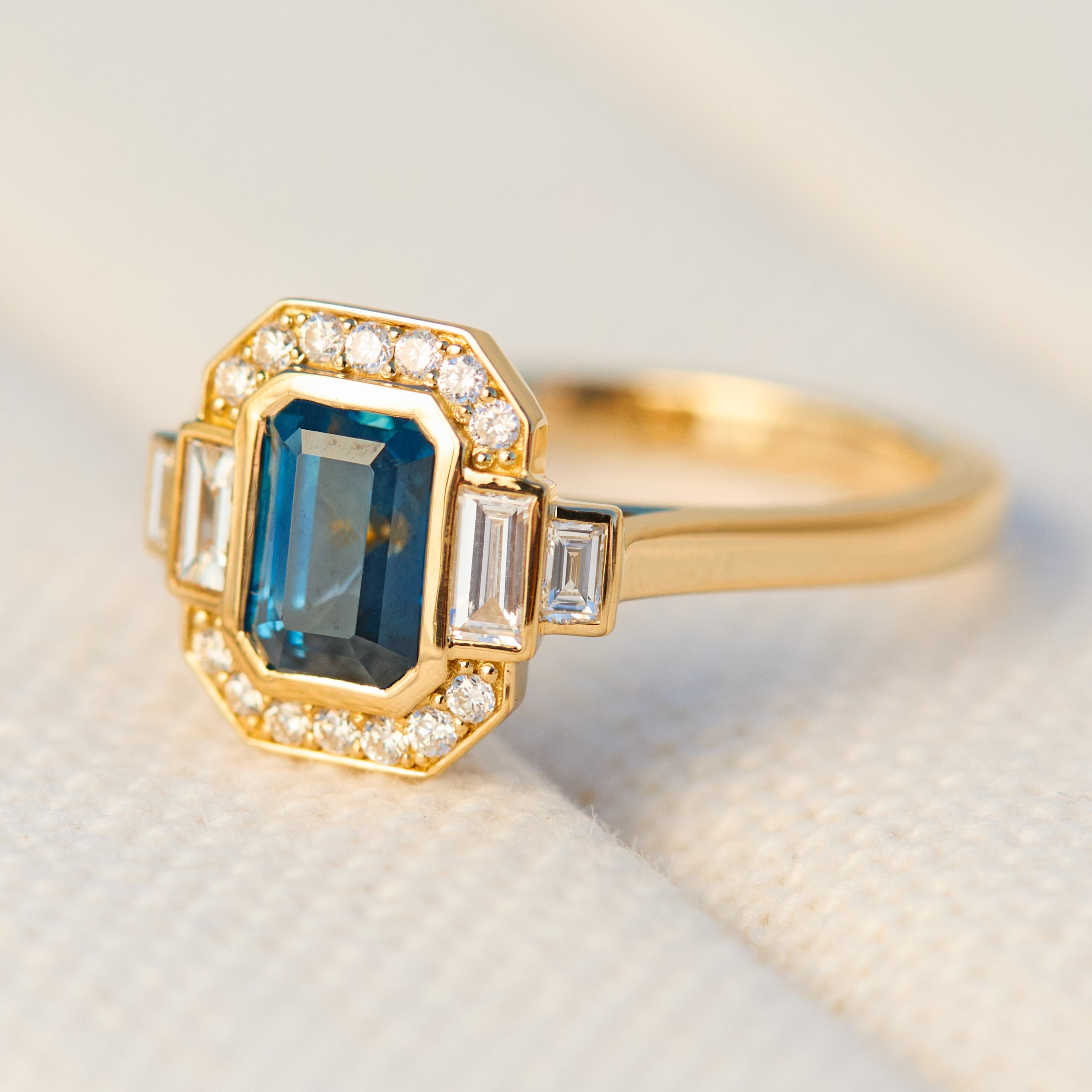 emerald cut blue sapphire one of a kind engagement ring in yellow gold