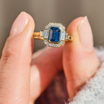 emerald cut blue sapphire one of a kind engagement ring in yellow gold