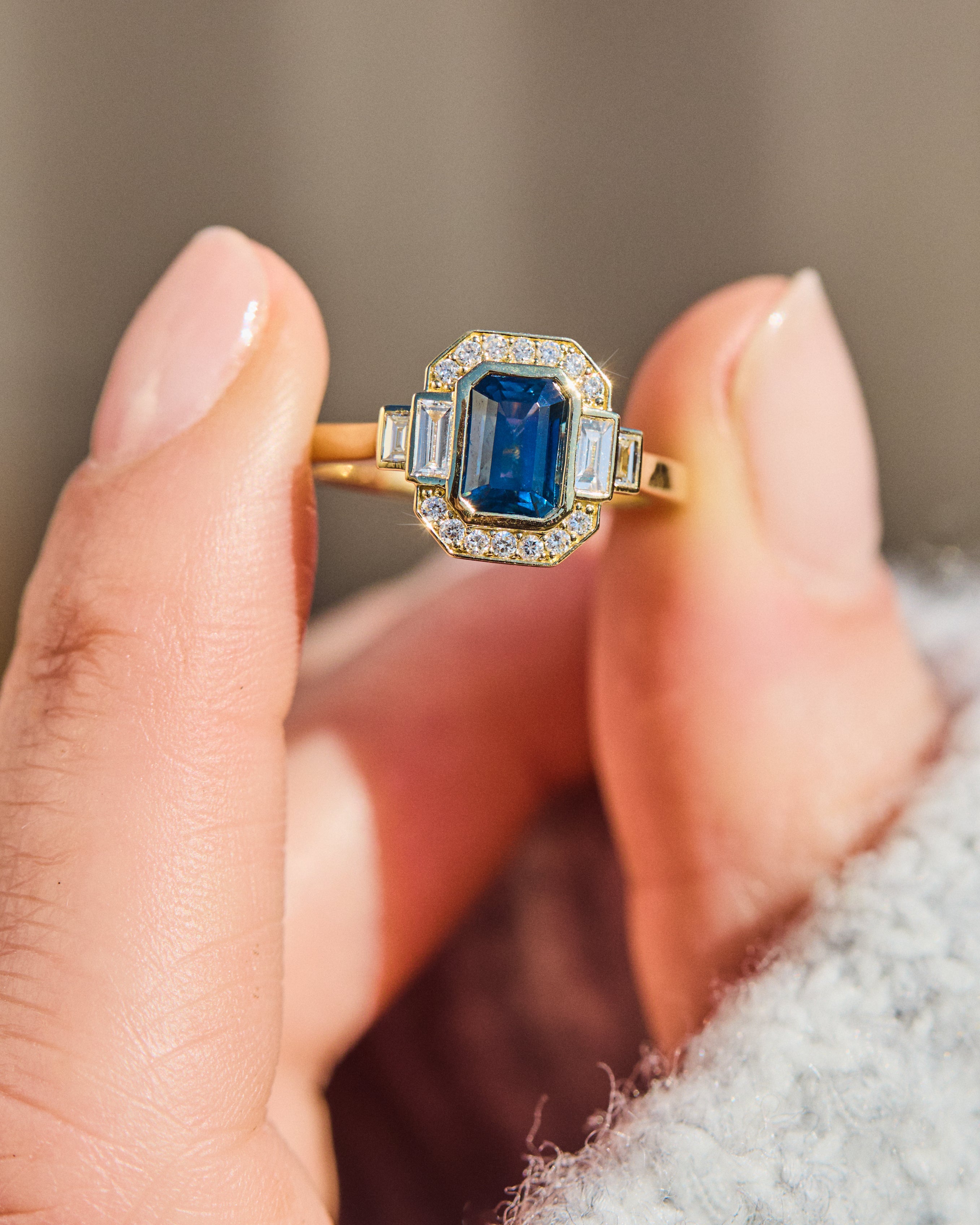 emerald cut blue sapphire one of a kind engagement ring in yellow gold