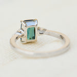 emerald cut blue teal sapphire trilogy engagement ring in platinum