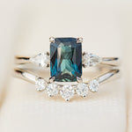 emerald cut blue teal sapphire trilogy engagement ring in platinum