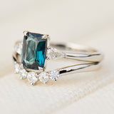 emerald cut blue teal sapphire trilogy engagement ring in platinum