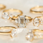 emerald cut lab grown diamond trilogy engagement ring set in yellow gold