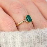 emerald cut emerald trilogy engagement ring set in yellow gold