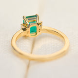 emerald cut emerald trilogy engagement ring set in yellow gold