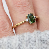 emerald cut green sapphire ring in yellow gold