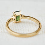 emerald cut green sapphire ring in yellow gold