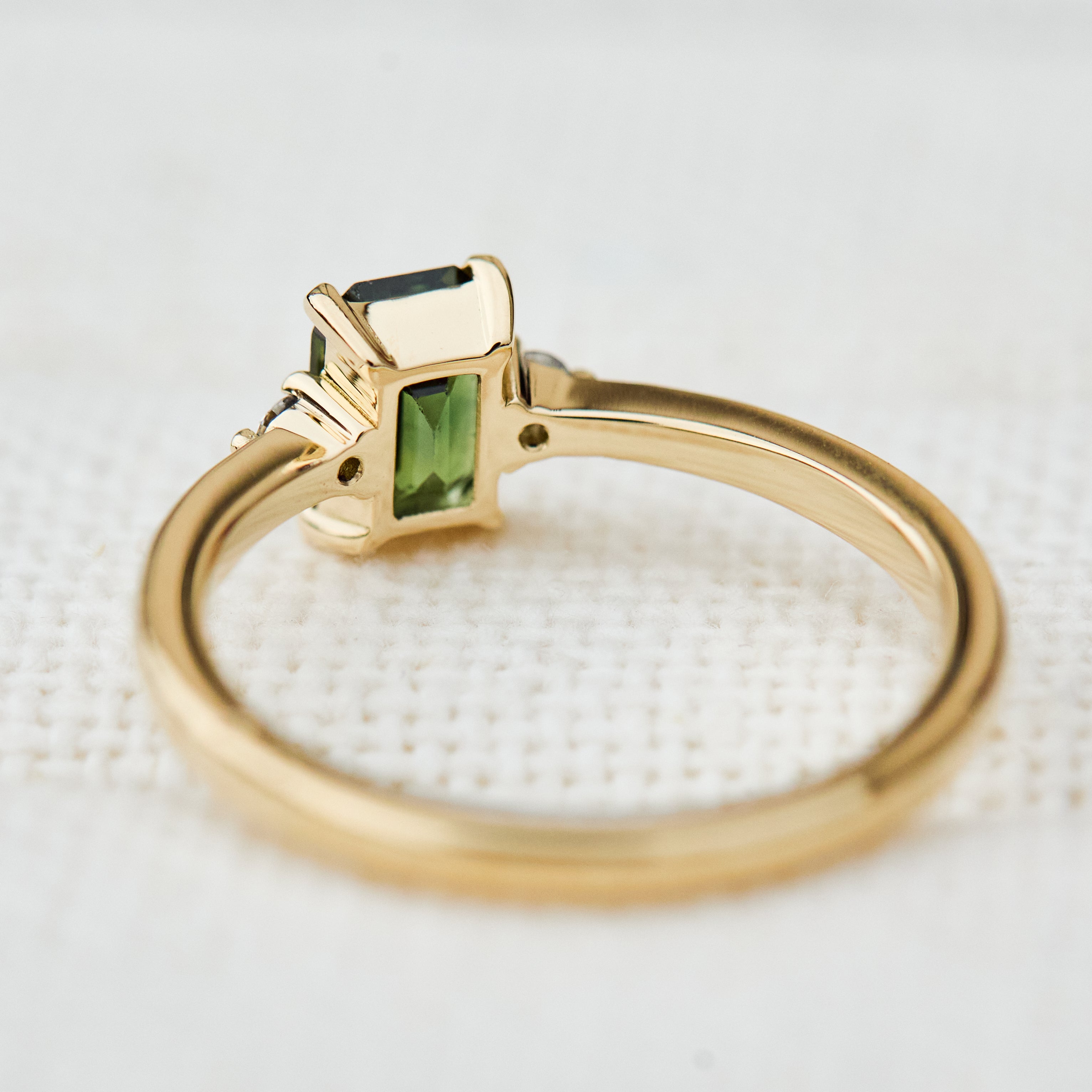 emerald cut green sapphire ring in yellow gold