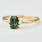 emerald cut green sapphire ring in yellow gold