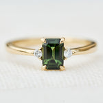 emerald cut green sapphire ring in yellow gold