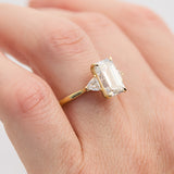 emerald cut lab grown diamond trilogy engagement ring set in yellow gold